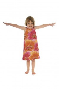 Little girl, LeapSmart student, in floral dress with arms outstretched